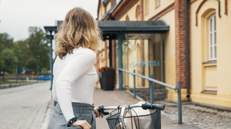 Girl with a bike going to the museum.