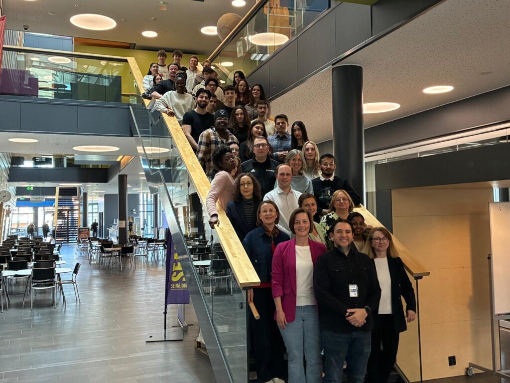 The whole group posing on the staircase.